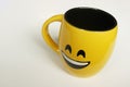 Mug on white background with smiley face and yellow color